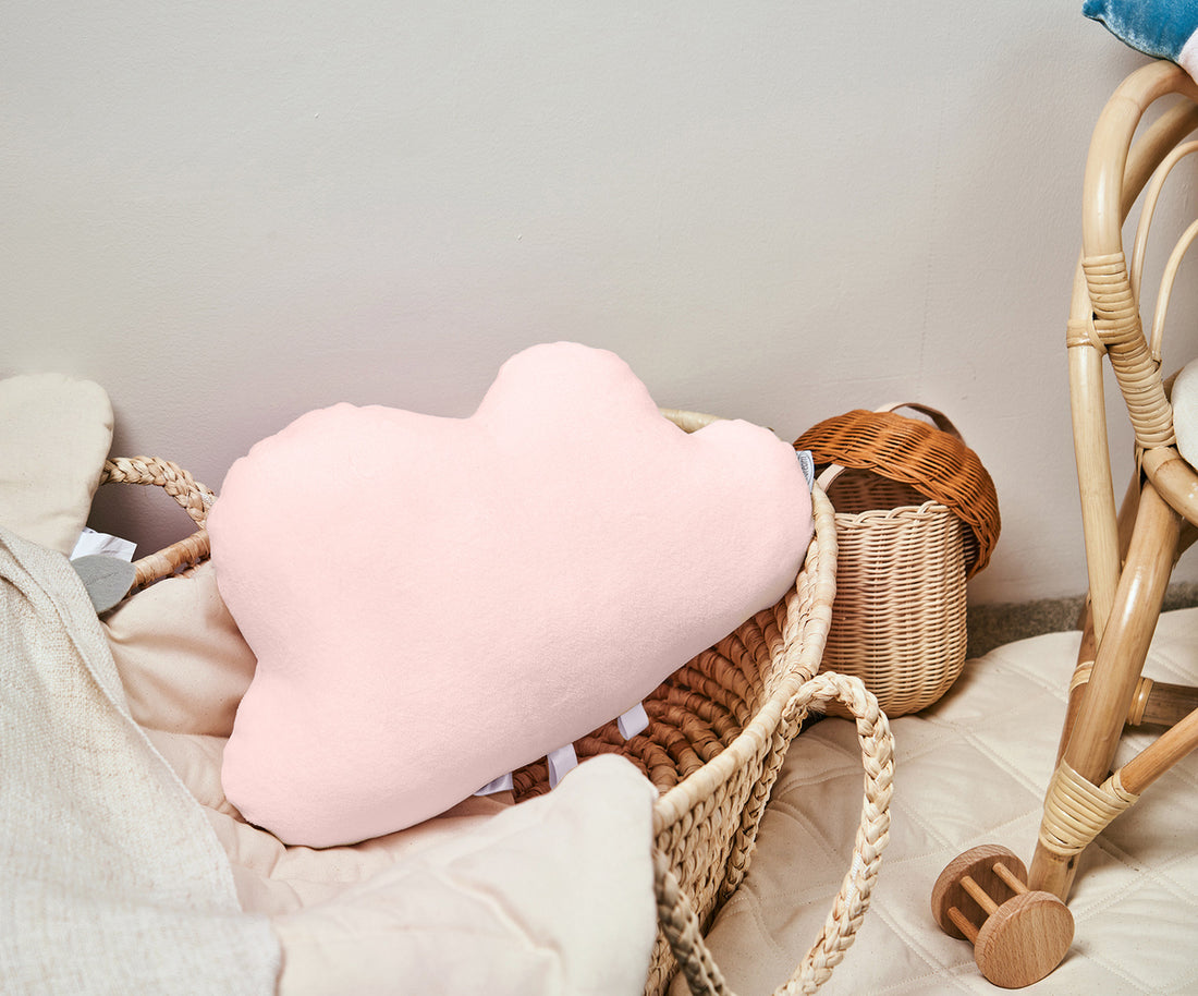 Pink cloud-shaped pillow on a gray background