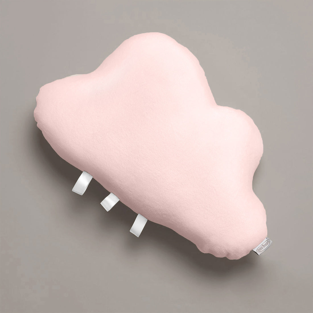 Pink cloud-shaped pillow on a gray background