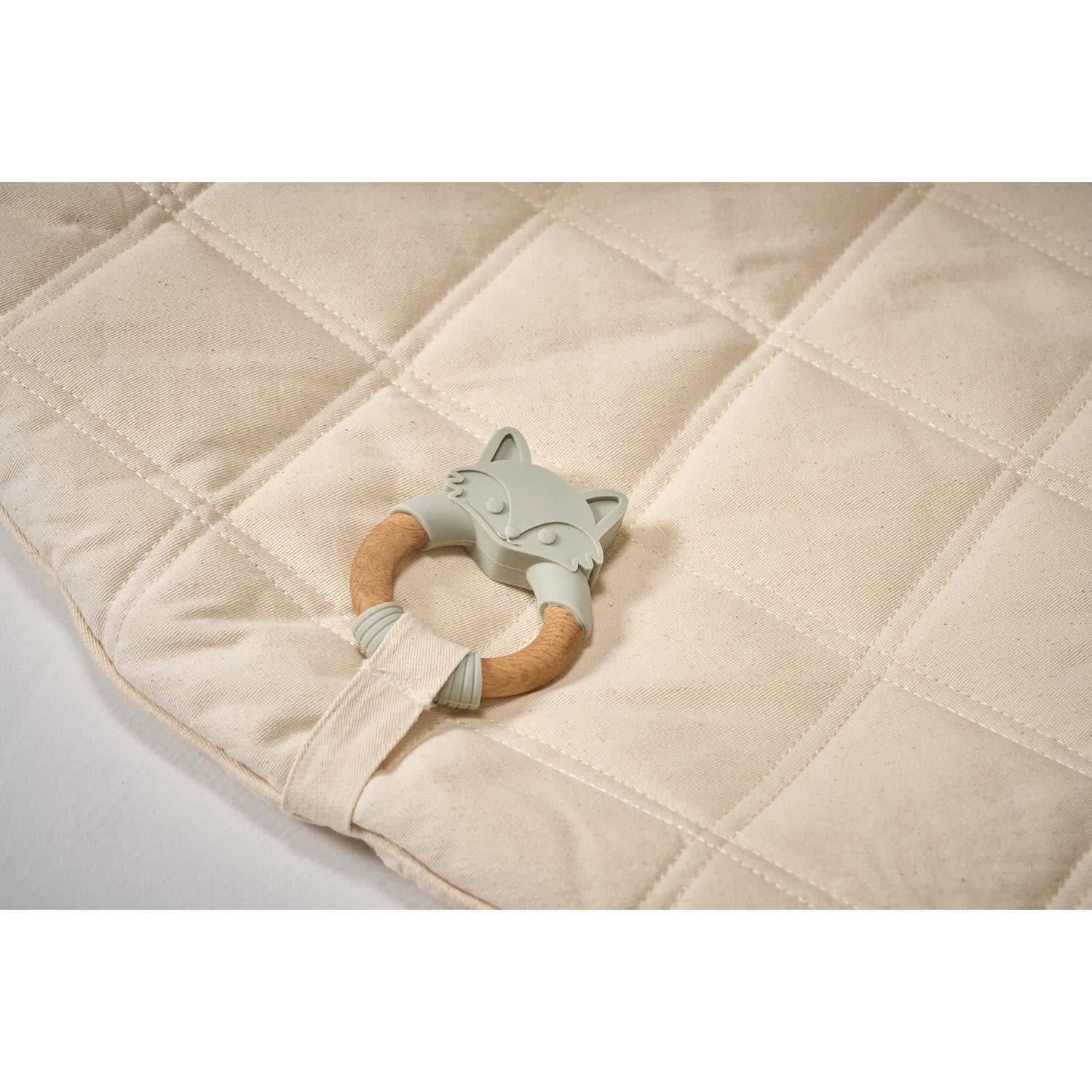 MiniDream baby teether attached with the playmat.