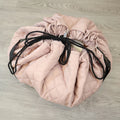 MiniDream 2-in-1 pink toy storage bag fully cinched closed with black drawstrings.