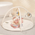A baby is playing with the MiniDream baby play mat.