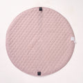 Solid pink reverse side of the MiniDream playmat laid flat, highlighting the quilted fabric texture.