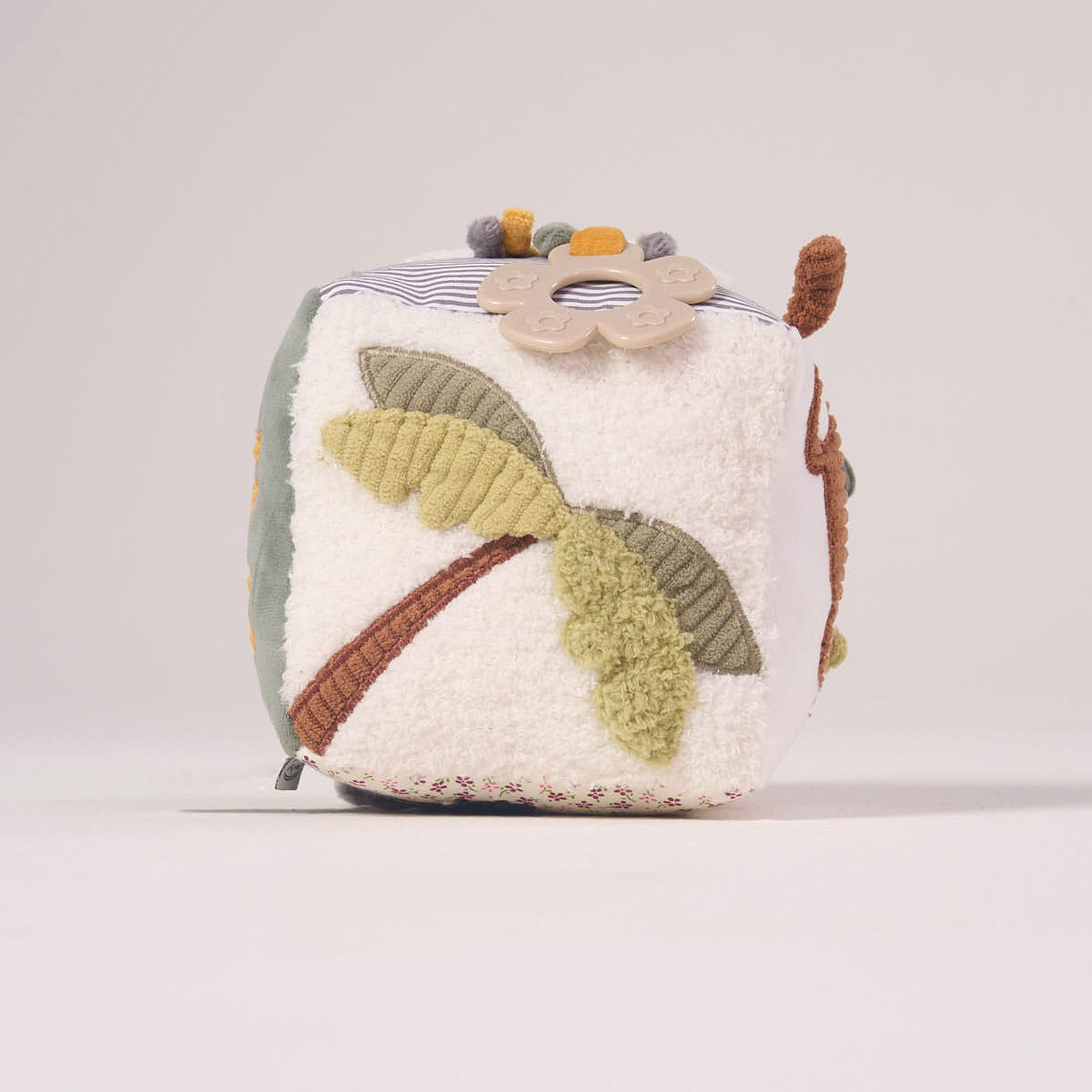 Close-up angled view of the MiniDream baby sensory toy focusing on the crinkly jungle leaves and high-quality, non-toxic textured fabrics.