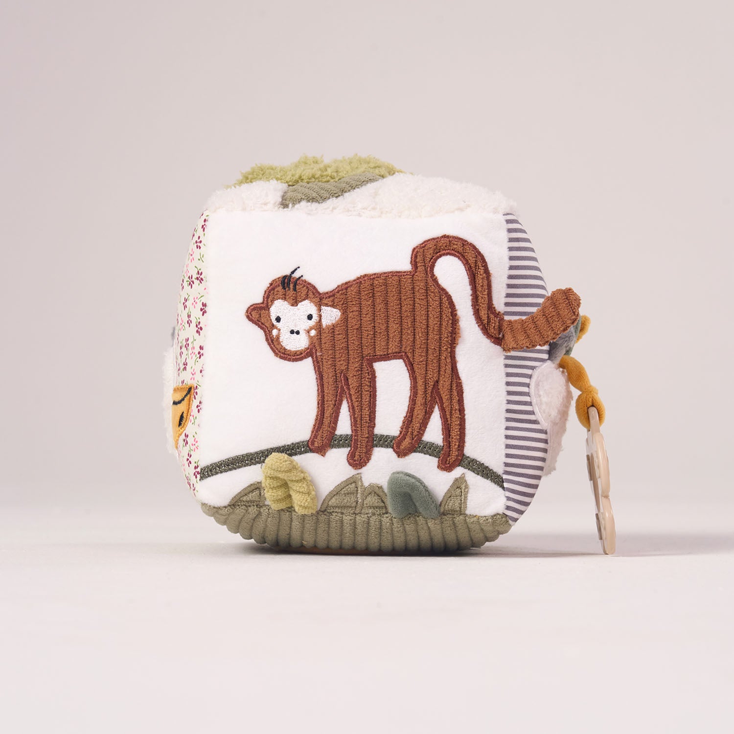 Side view of the MiniDream Jungle Soft Activity Cube showing a cute brown monkey hanging from a vine on soft, baby-safe fabric.