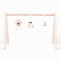 Wooden play gym with toys in a white background.