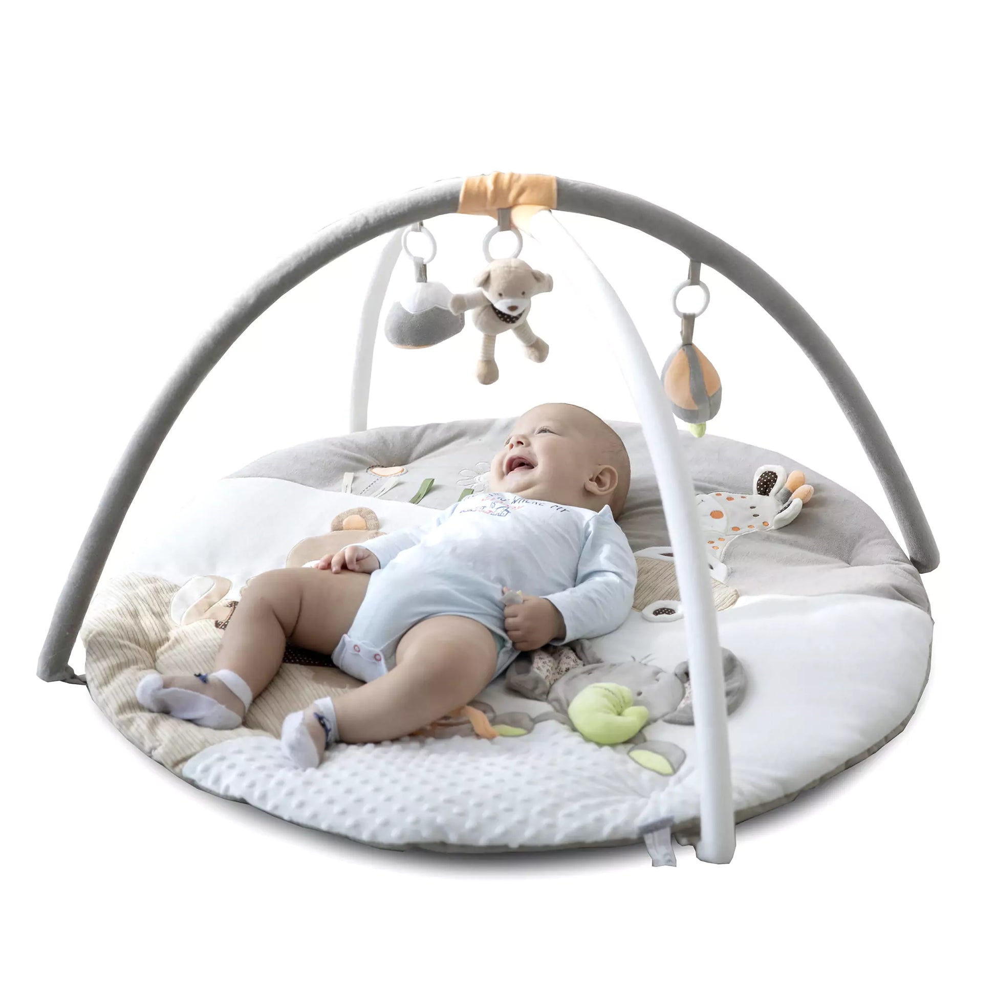 Baby exploring tummy time on cushioned safari mat with colorful animal prints.