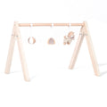 Wooden play gym with 3 hanging toys for babies.