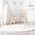 Wooden activity gym with toys displaying in a nursery